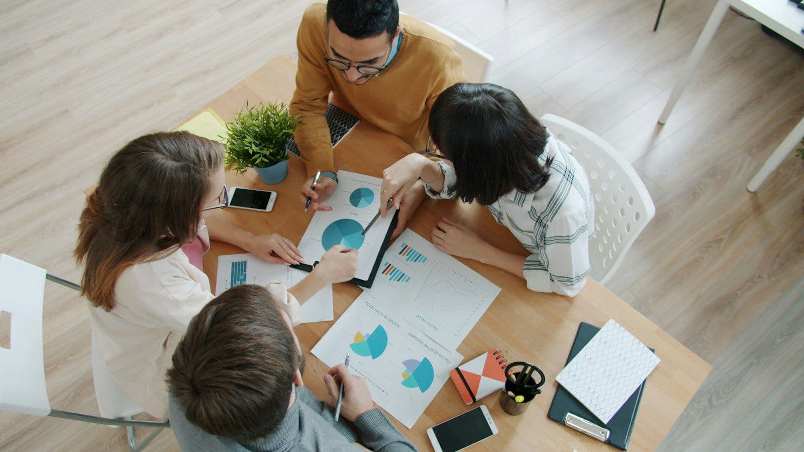 A marketing team planning a client's month around a table of charts